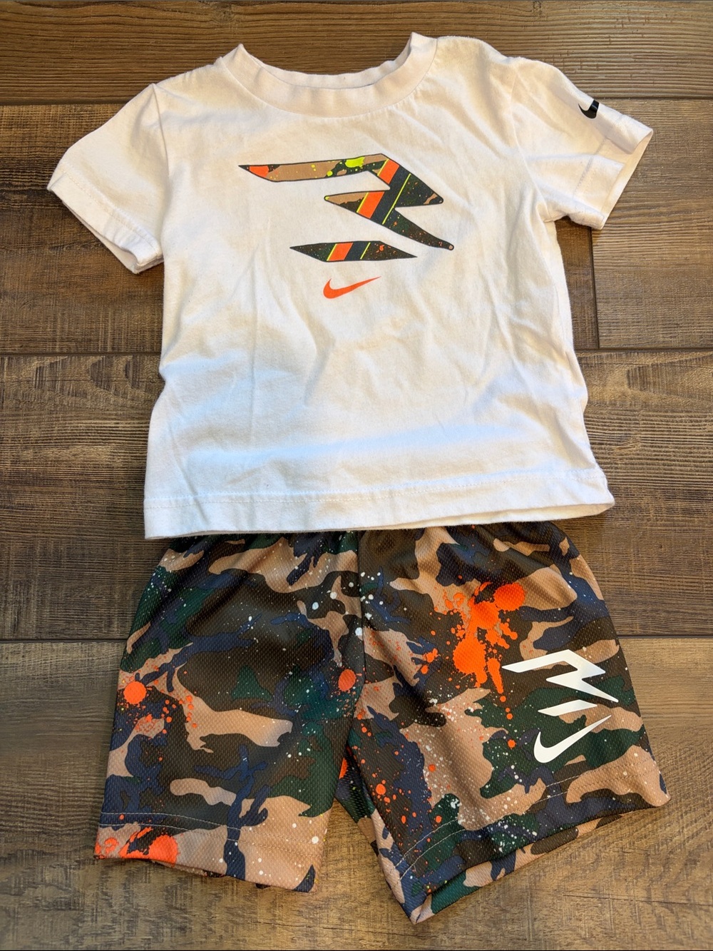 Nike Kids White Tee and Camo Shorts with Orange and Green Accents